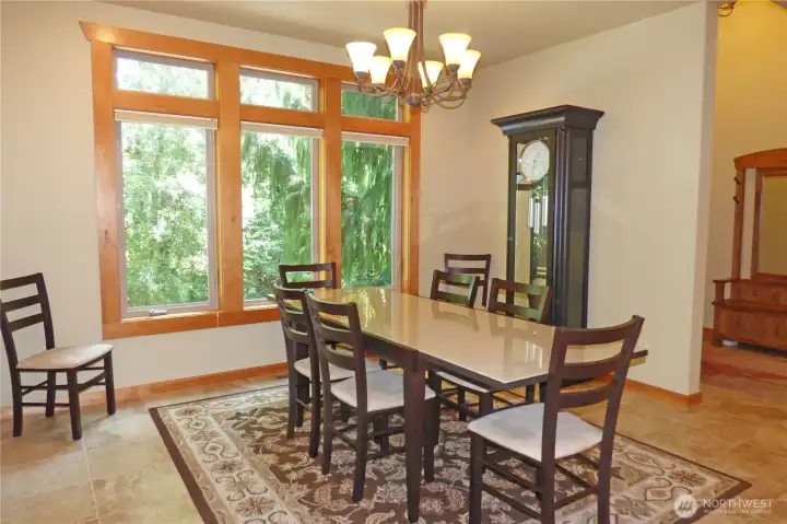 Large dining room with wood wrapped windows and grandfather clock (stays with home).
