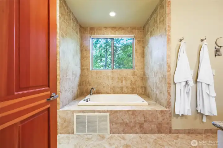 Nice private, soaking, jetted tub with window above.