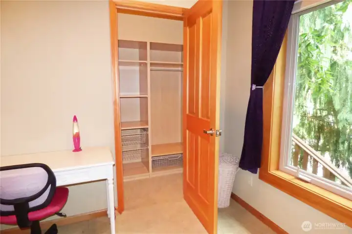 Walk-in closet with builts-ins and a light.