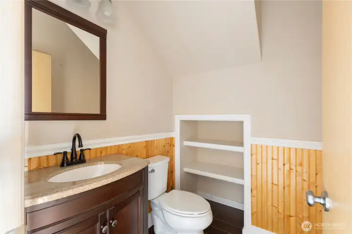 Adorable half bath next to the garage.