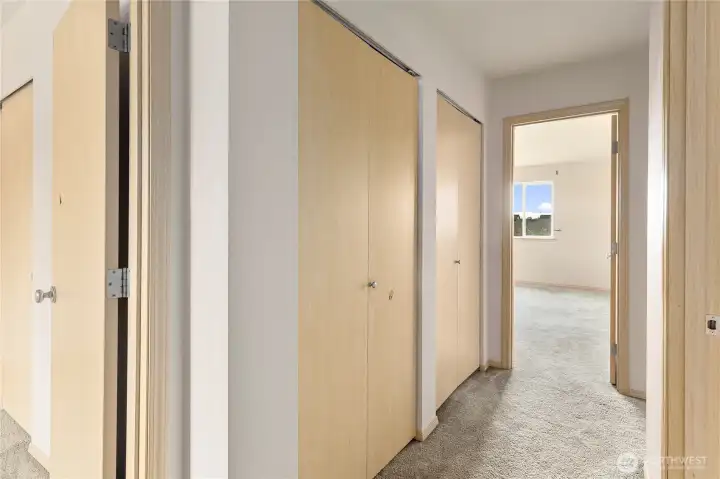 So much storage in the hall closets as you approach the Primary bedroom.