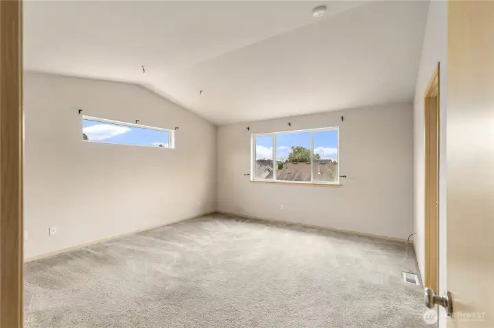 Huge Primary bedroom with vaulted ceilings,  ensuite and walk in closet.