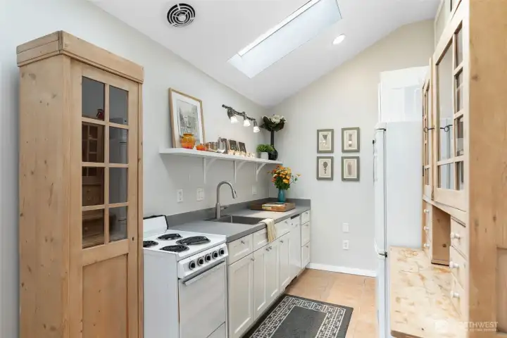 ...that opens to a very efficient fully equipped kitchen with a combo washer/dryer.