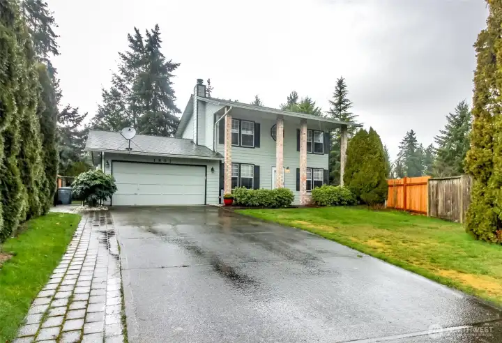 Two car garage with extra long driveway offers ample guest parking.