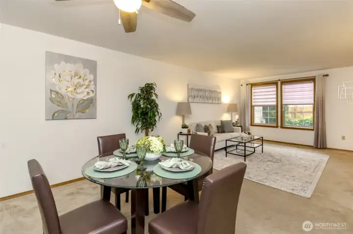 Dining room facing the front yard and living room. Ceiling fan and freshly shampooed carpets.