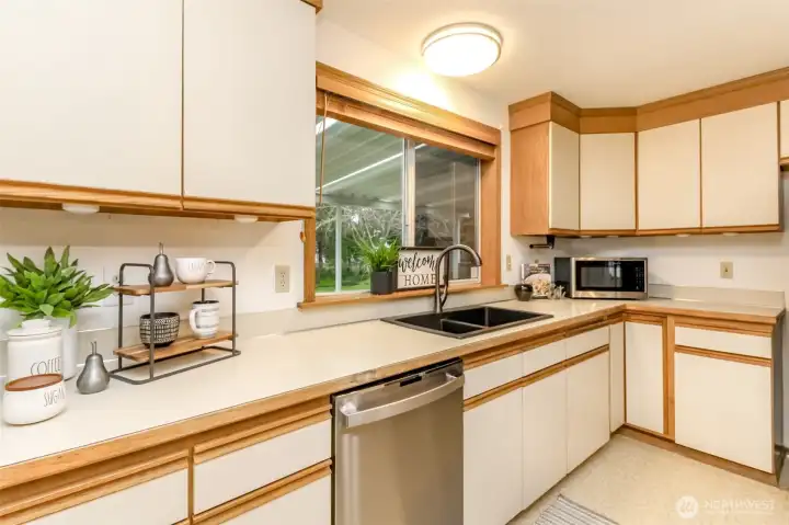 The view out the window is of the backyard, deck, patio and shed.