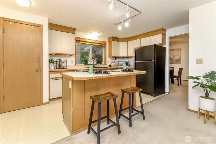 From this angle of the kitchen you can see the dining room / living room areas. The door in the picture is the pantry.