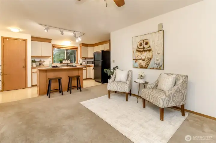 Spacious family room off of the kitchen with two windows that face the front yard and full length covered porch.