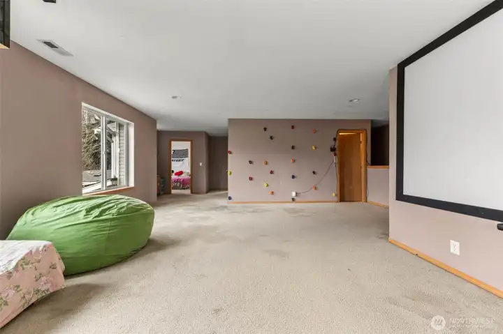 Loft with climbing wall and additional bedrooms to the left, and bathroom to the right