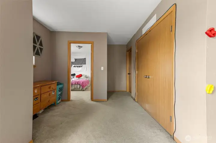 Hallway to additional bedrooms and laundry