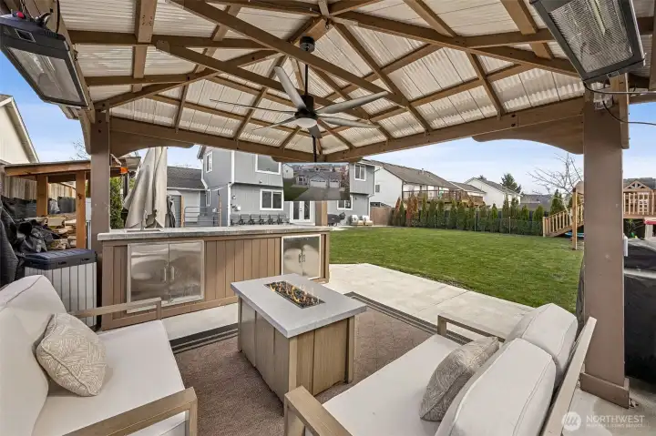 The expansive covered patio is a true private retreat, complete with heaters and a convenient kitchenette—perfect for entertaining or relaxing outdoors year-round.