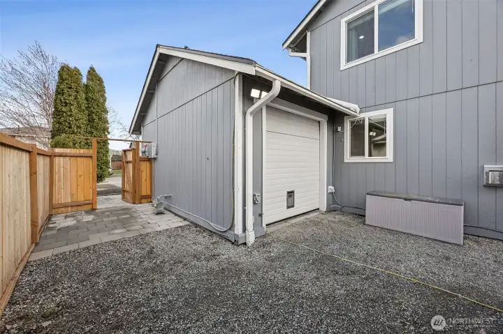 Behind the third car garage bay it opens to the backyard. Home also has a interlock for the generator.