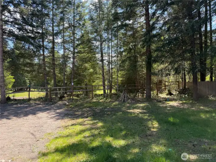 Beautiful back yard of parcel. Adjacent open lot behind.