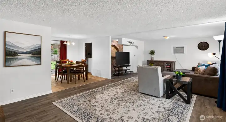 This expansive great room offers an ideal blend of openness and comfort, connecting seamlessly to the dining area for effortless flow between spaces. Updated flooring, warm textures, and inviting finishes create a welcoming environment that feels both functional and comfortable for everyday living.