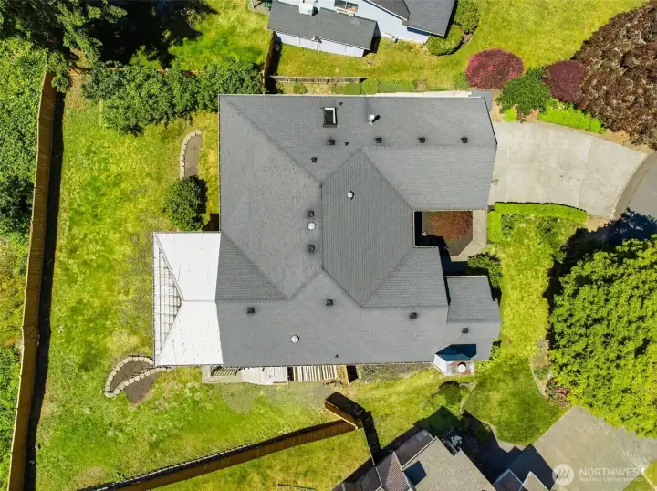 Aerial Lot View - Bird's-eye view showcasing the generous homesite, oversized backyard, and impressive covered deck structure.