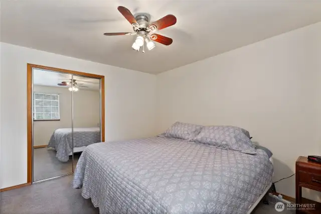 Another full mirrored closet and ceiling fan for comfort.
