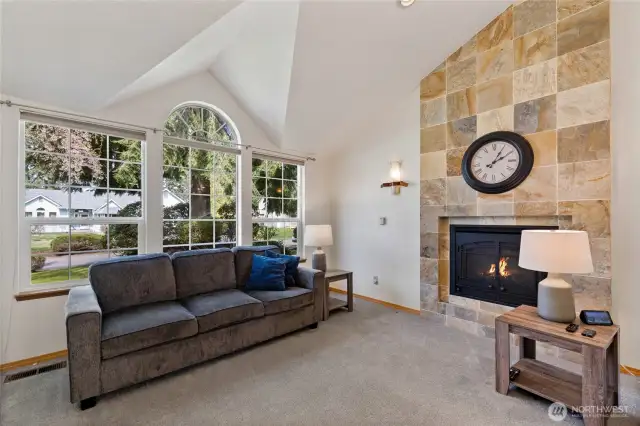 The formal living room with a beautiful gas fireplace and earthy tones allow you to bring in whatever palate you desire.