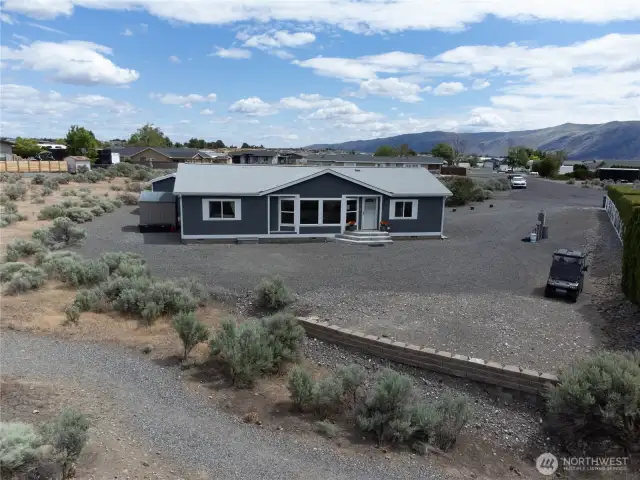 Aerial view front of home with walking trail to River.