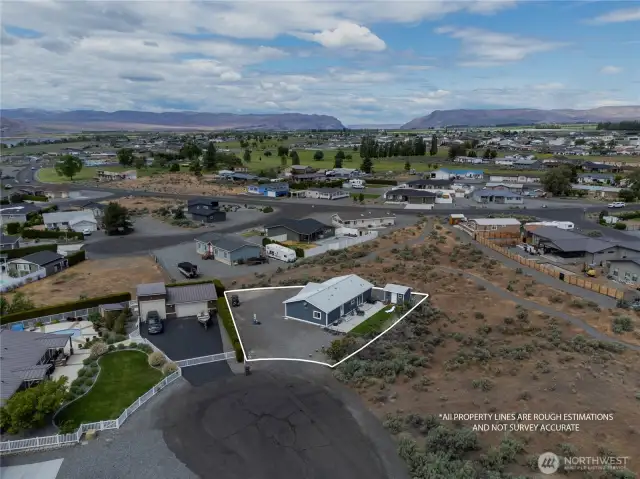 Aerial view of home in cul-de-sac.