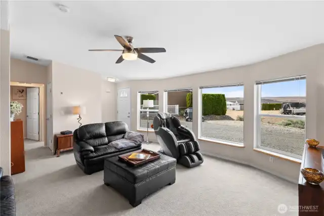 Living room with ceiling fan and fresh paint.