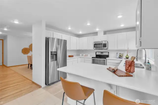 Sleek lines for this bright and modern kitchen featuring newer stainless steel appliances and new countertops.