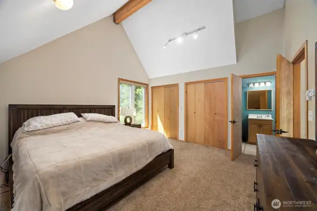 Primary bedroom w/ vaulted ceilings.