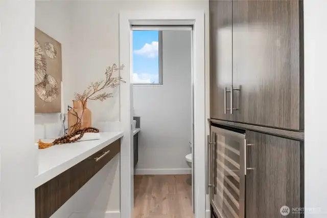 Desk and Custom California Closet Design including a wine refrigerator.