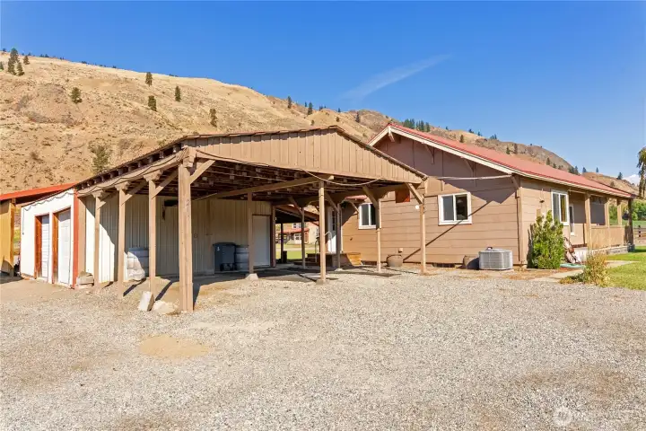 Covered parking and garage space provide practical storage and convenience for vehicles and farm gear.