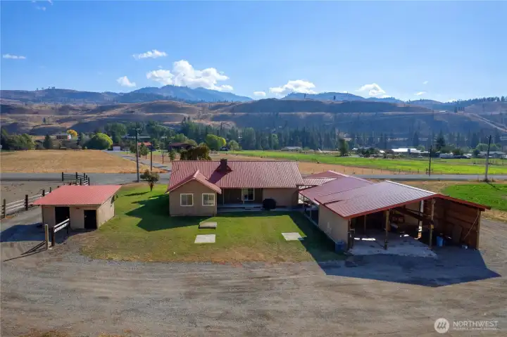 Expansive valley views highlight the acreage with open pastures, fencing, and endless space for farming or recreation.