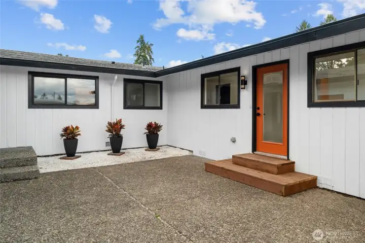 2ND FRONT ENTRANCE | This door accesses the wing of the home that features a primary bedroom, bathroom and sitting area. Perfect for making this a private multi-gen or rentable space.