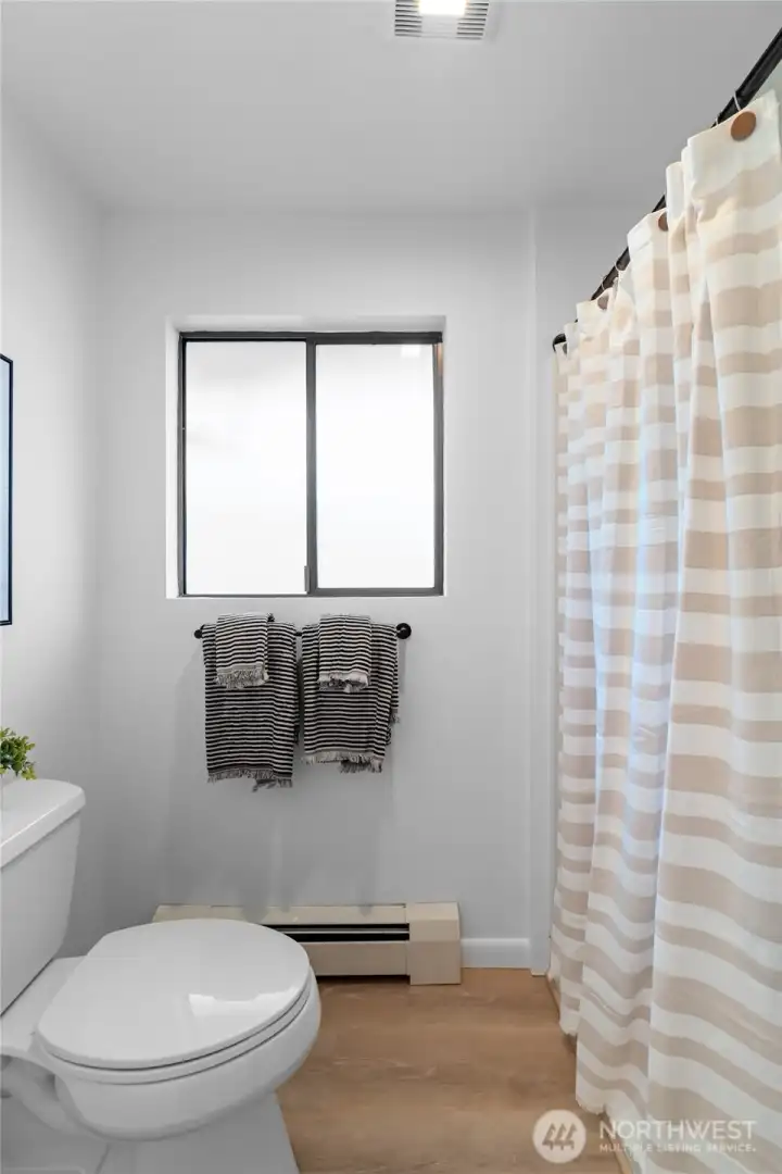 PRIMARY BEDROOM 2 BATHROOM | With a new fan, fresh paint and flooring, this bright little bathroom is perfect.