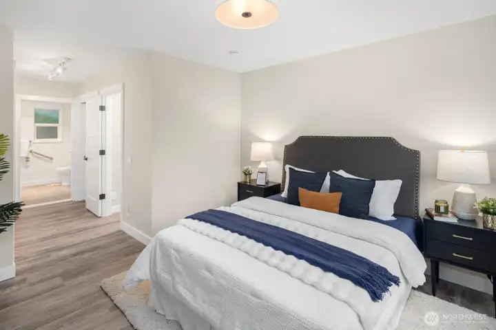 The primary suite features a custom closet system and en-suite bath with an oversized, beautifully tiled shower.