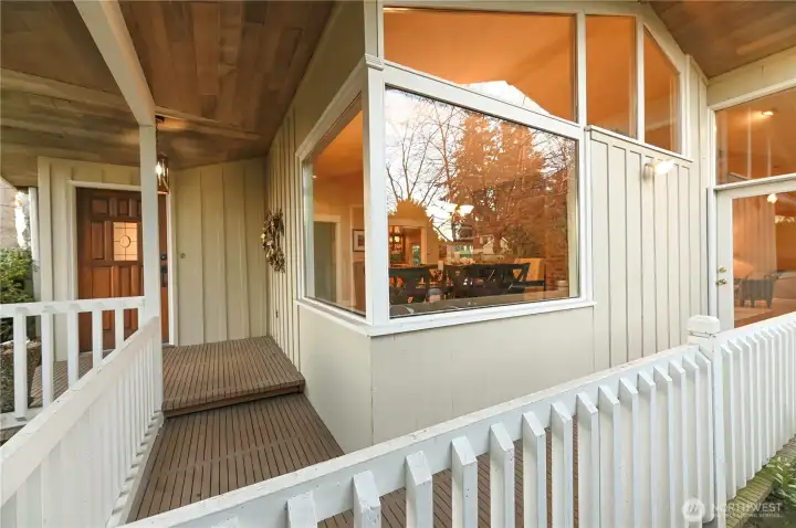 Covered front porch wraps to the fully fence side courtyard.