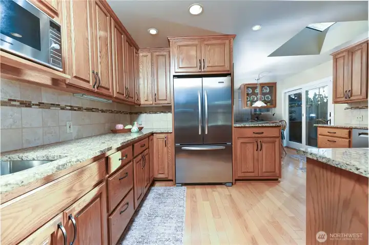 A truly unique kitchen designed for culinary creativity, featuring generous counter space, ample cabinetry, and abundant storage. This inspiring space has been the heart of catering for numerous parties, weddings, and fundraising events.