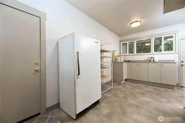 A finished bonus room off the wine room and garage offers exceptional flexibility. Designed for gift wrapping with a dedicated wrap drawer, it has also served as a workroom and canning storage—proof that every inch of this home was intentionally and thoughtfully planned.