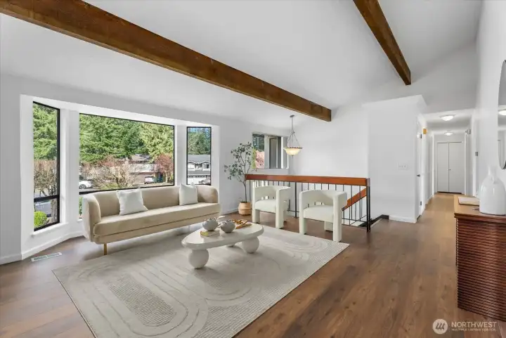 Wood fireplace & a large bay window with natural light.