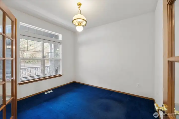 Flexible room with French doors and natural light, ideal for a home office, den, or hobby space.