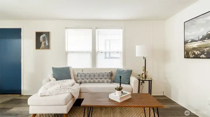 Living room has lots of Windows to bring in the light