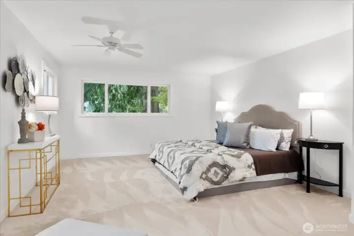 Primary suite spans nearly half the upper level—light-filled retreat with enclosed balcony, walk-in closet & spa-like bath.