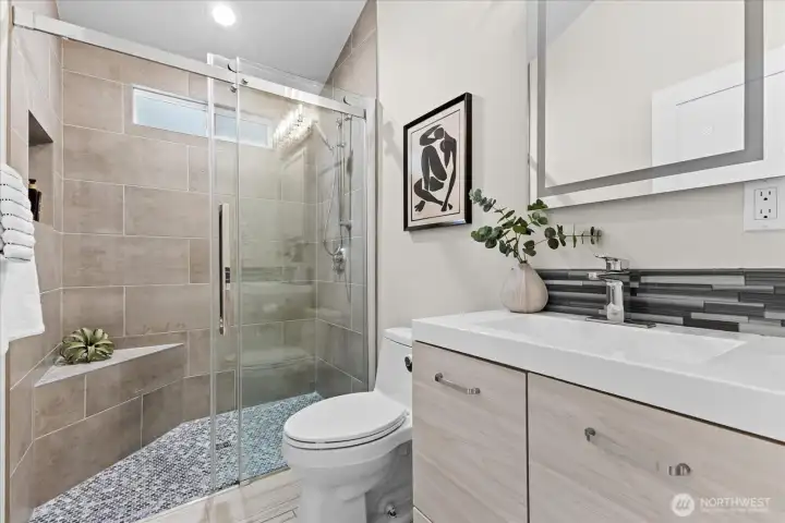 Primary bathroom is remodeled with walk in shower.