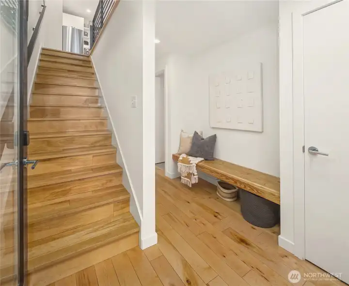 First level entryway bench seating with coat closet, stairs leading to main level First level entryway bench seating with coat closet, stairs leading to main level