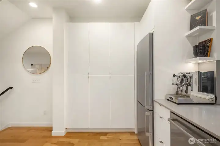 Kitchen with full pantry wall for ample storage, fully enclosed fridge Kitchen with full pantry wall for ample storage, fully enclosed fridge