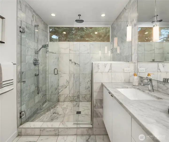 Large walk-in shower with overhead rain shower plus separate shower bar. Calacutta marble, stone countertop Large walk-in shower with overhead rain shower plus separate shower bar. Calacutta marble, stone countertop