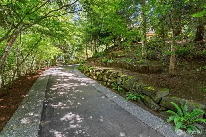 Meticulously landscaped driveway with engineered drainage system. Meticulously landscaped driveway with engineered drainage system.
