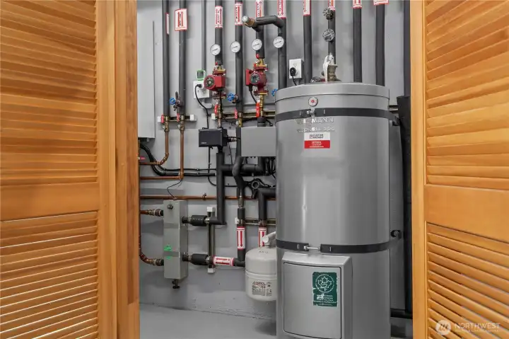 The utility closet is located in the garage and houses the heating and cooling elements for the home in addition to a tankless water heater. The utility closet is located in the garage and houses the heating and cooling elements for the home in addition to a tankless water heater.