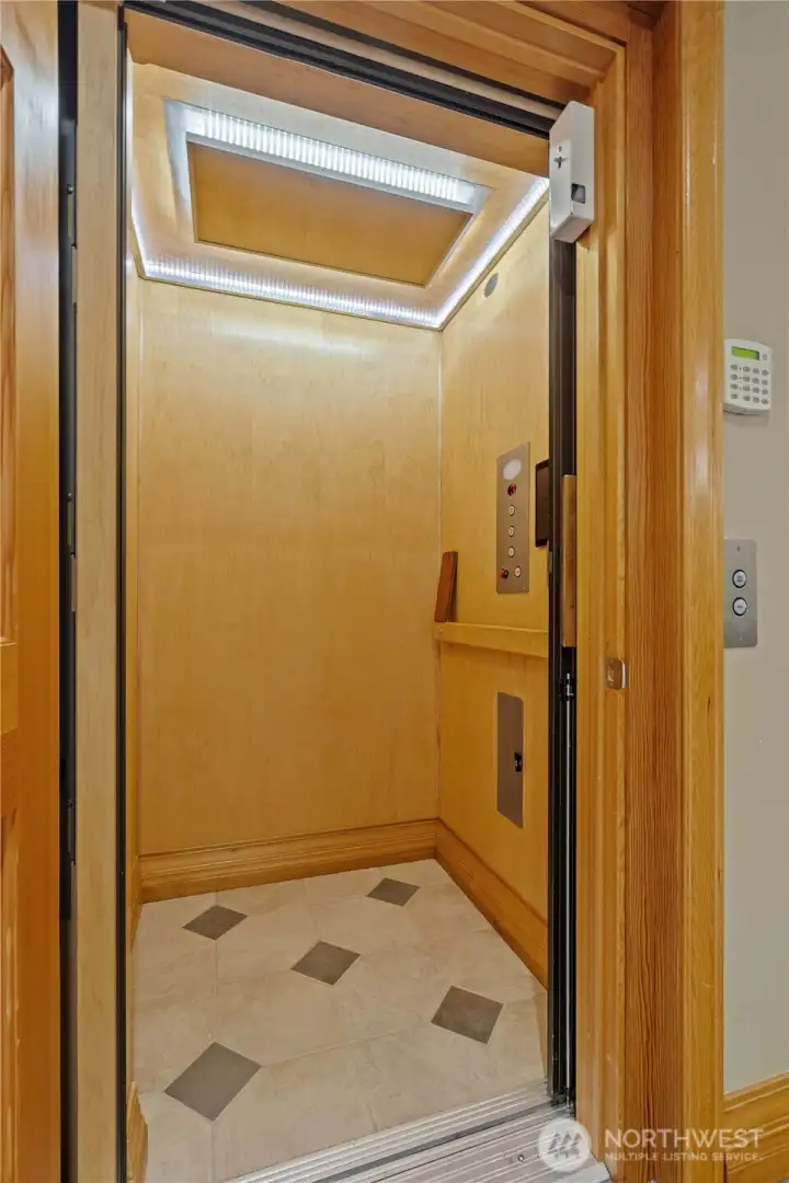 Hydraulic elevator in home offers access to the garage level, main level and upstairs. Hydraulic elevator in home offers access to the garage level, main level and upstairs.