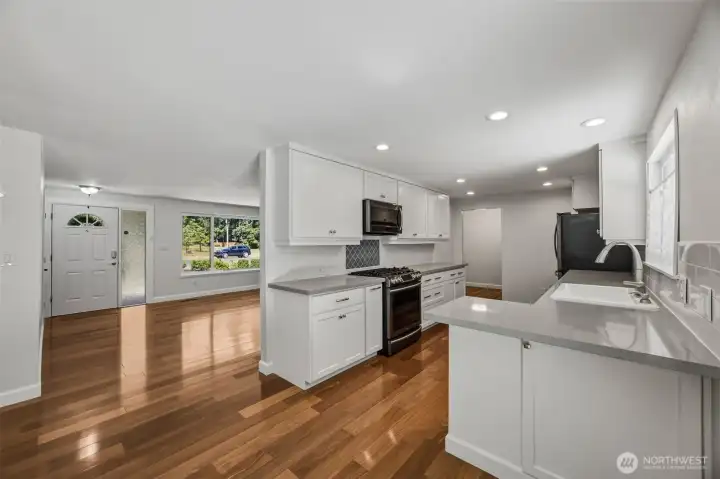 View of the living room and kitchen from the dining room.