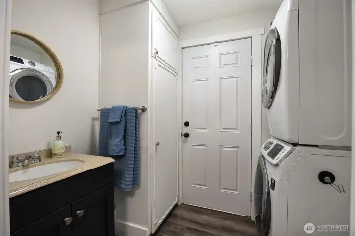 Half bathroom with washer & dryer in main home.