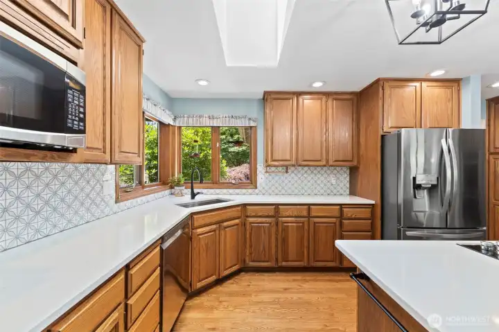 Marble backsplash in the kitchen. Skylight and large kitchen windows bring in great, natural light.