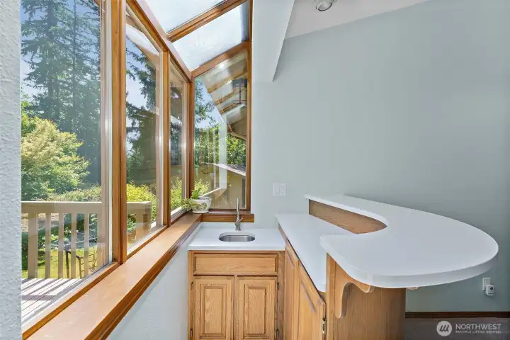 Wet bar area in great room, with windows over looking private back yard.